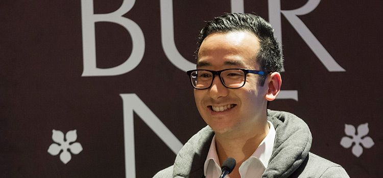 Liem industry placement student stories Swinburne student, Liem, at a lectern in front of Swinburne University branding.